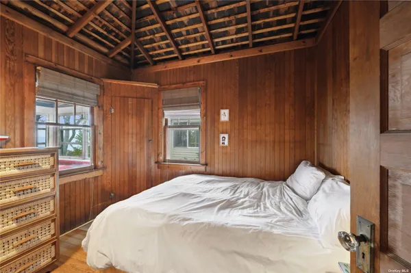 a bed sitting in a bedroom next to a window