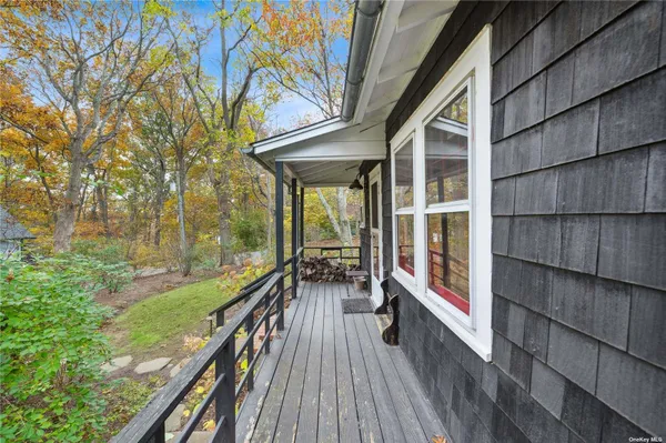 a view of balcony with wooden floor and fence