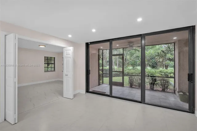a view of an empty room with glass door