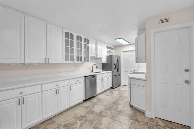 a kitchen with sink and cabinets