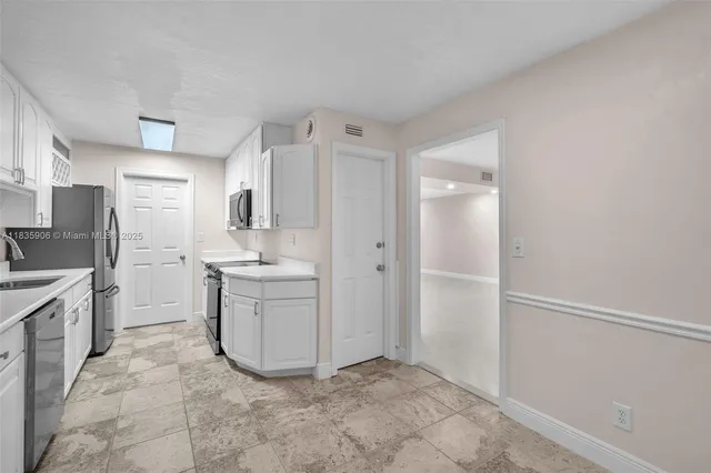 a room with a sink and a stove top oven