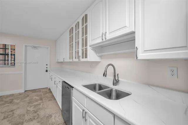 a kitchen with stainless steel appliances granite countertop a sink and cabinets
