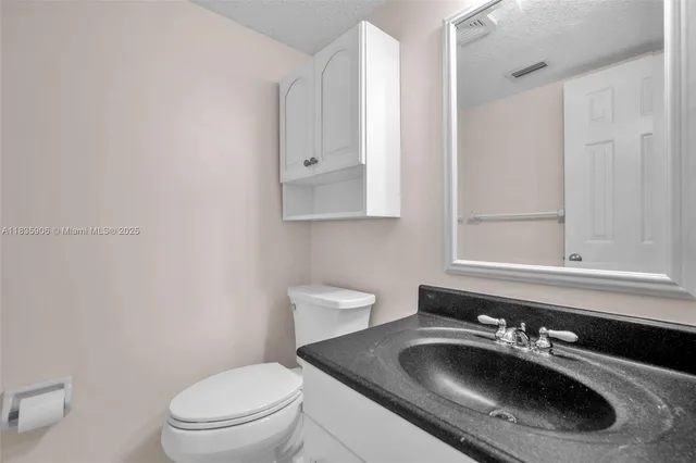 a bathroom with double sink and a mirror