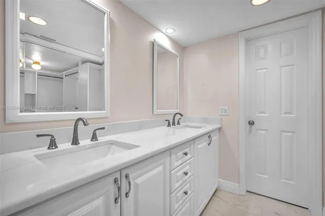 a bathroom with a double vanity sink and mirror