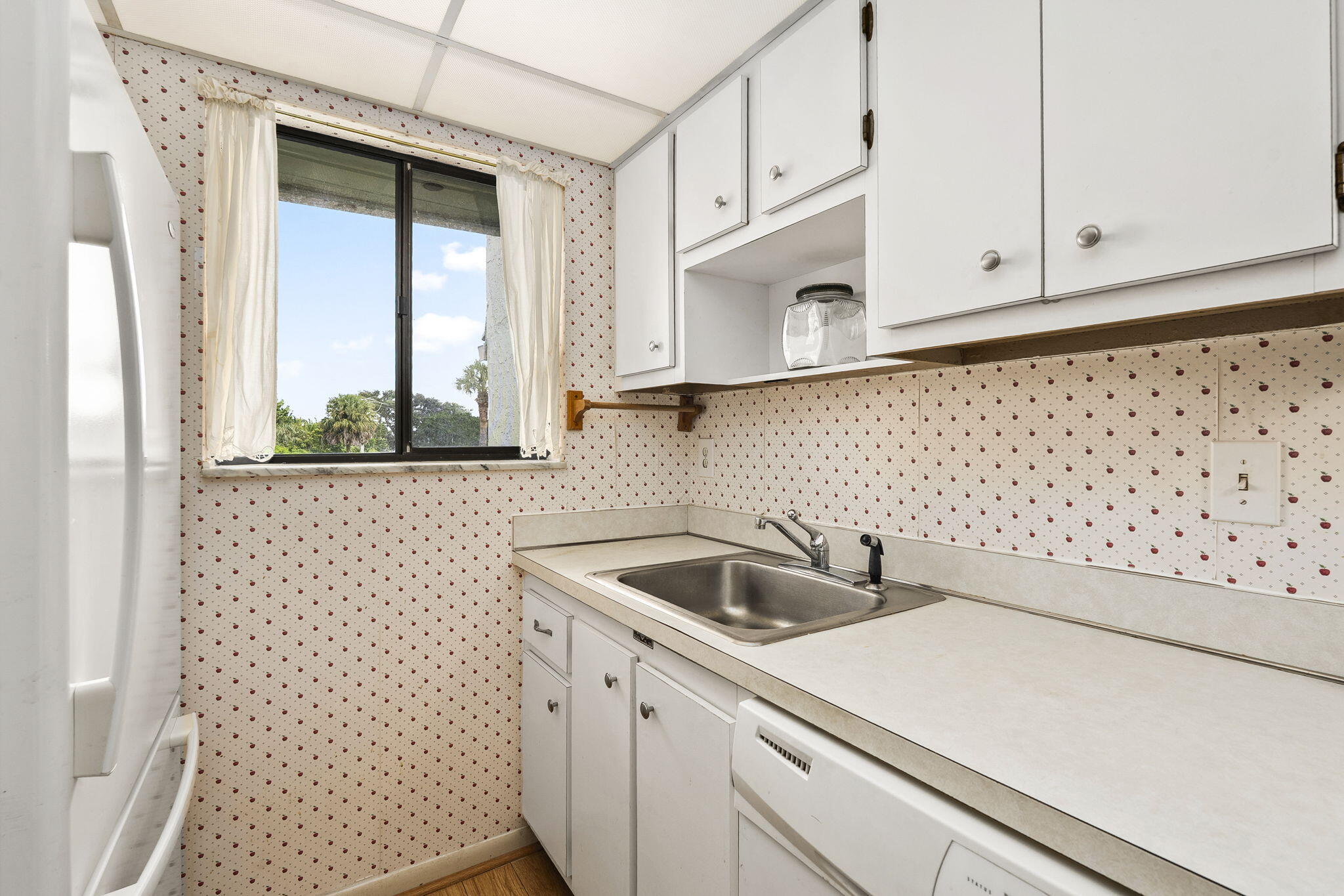 5413 Southeast Miles Grant Road, Unit G206 Stuart, FL 34997 - Photo 18 of 31 a kitchen with a sink and cabinets