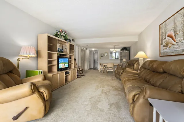 a dining room with furniture a chandelier and fireplace