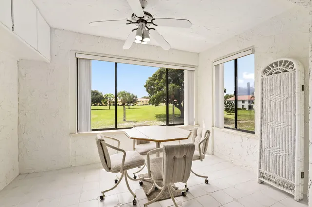 a dining room with furniture a chandelier and fireplace