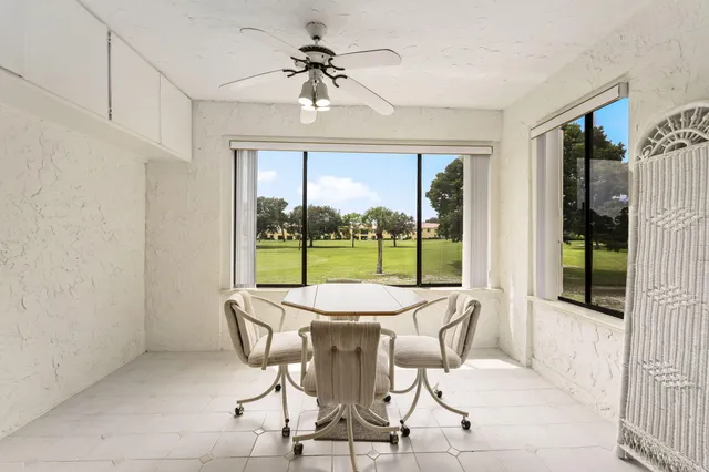 a bedroom with a bed and a dresser next to a window