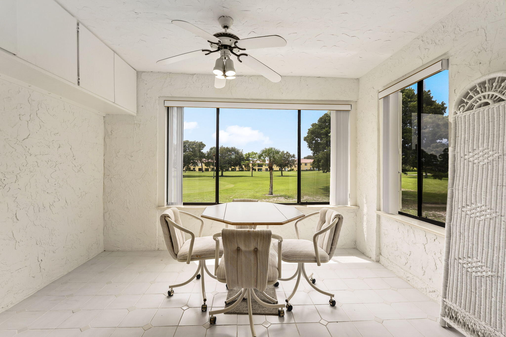 5413 Southeast Miles Grant Road, Unit G206 Stuart, FL 34997 - Photo 10 of 31 a dining room with furniture a chandelier and fireplace