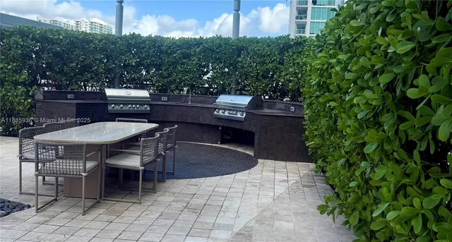 a view of a patio with a table and chairs