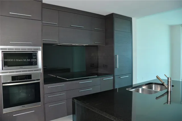 a kitchen with a microwave and a stove top oven