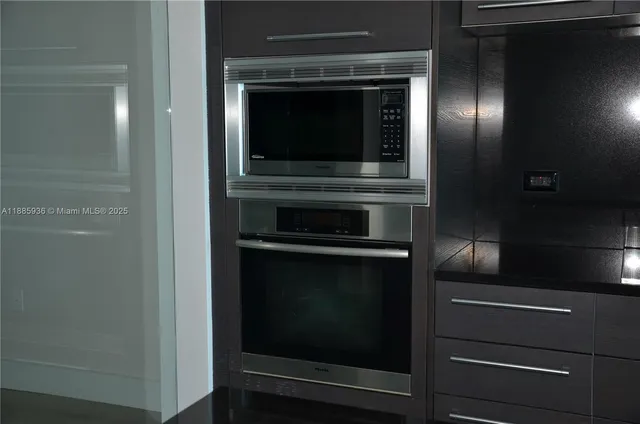 a stove top oven sitting inside of a kitchen
