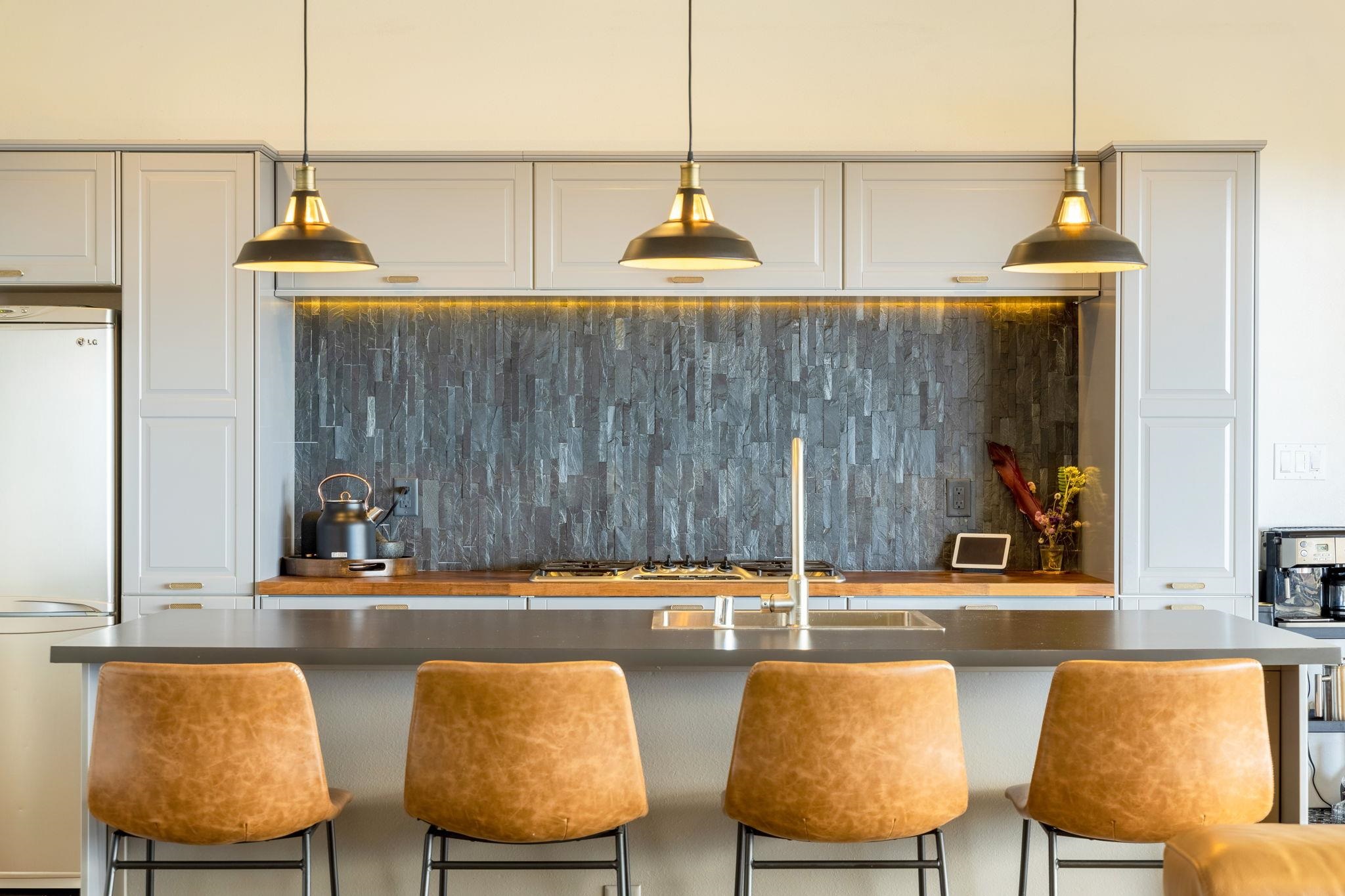 59 Waipoli Road Kula, HI 96790 - Photo 12 of 47 a kitchen with a table chairs and a lamp