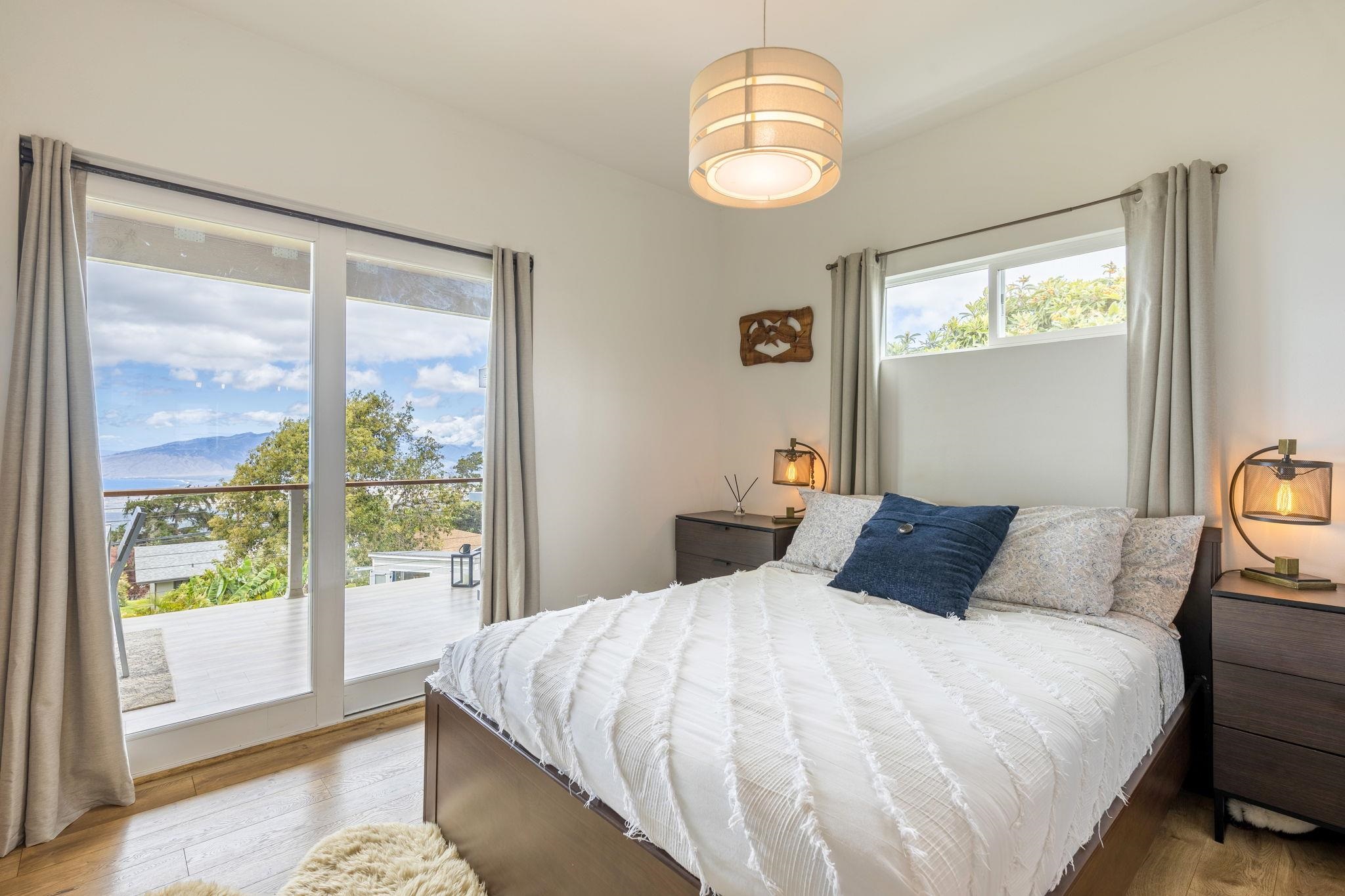 59 Waipoli Road Kula, HI 96790 - Photo 23 of 47 a bedroom with a large bed and a large window