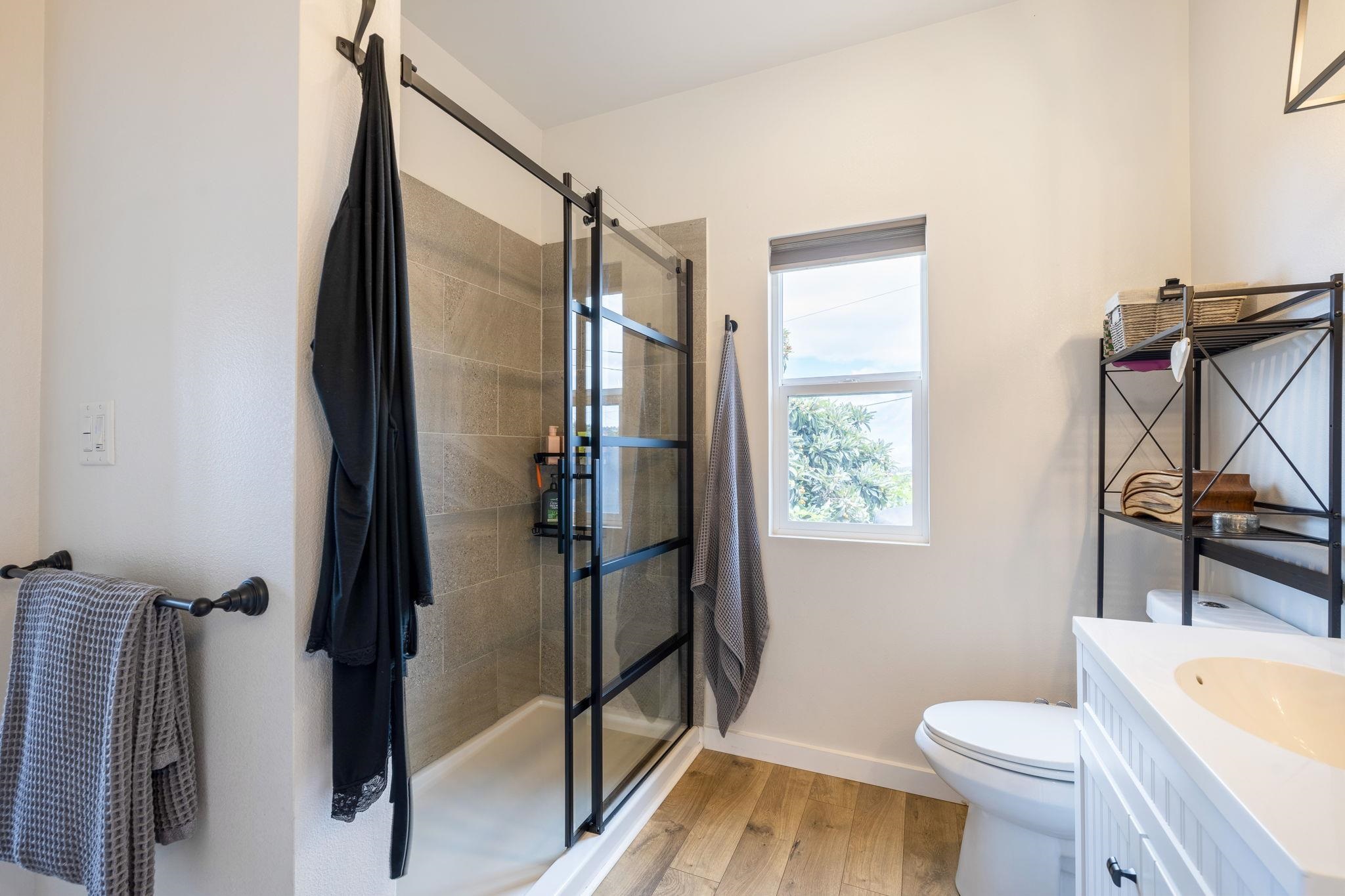 59 Waipoli Road Kula, HI 96790 - Photo 26 of 47 a bathroom with a granite countertop sink toilet and shower