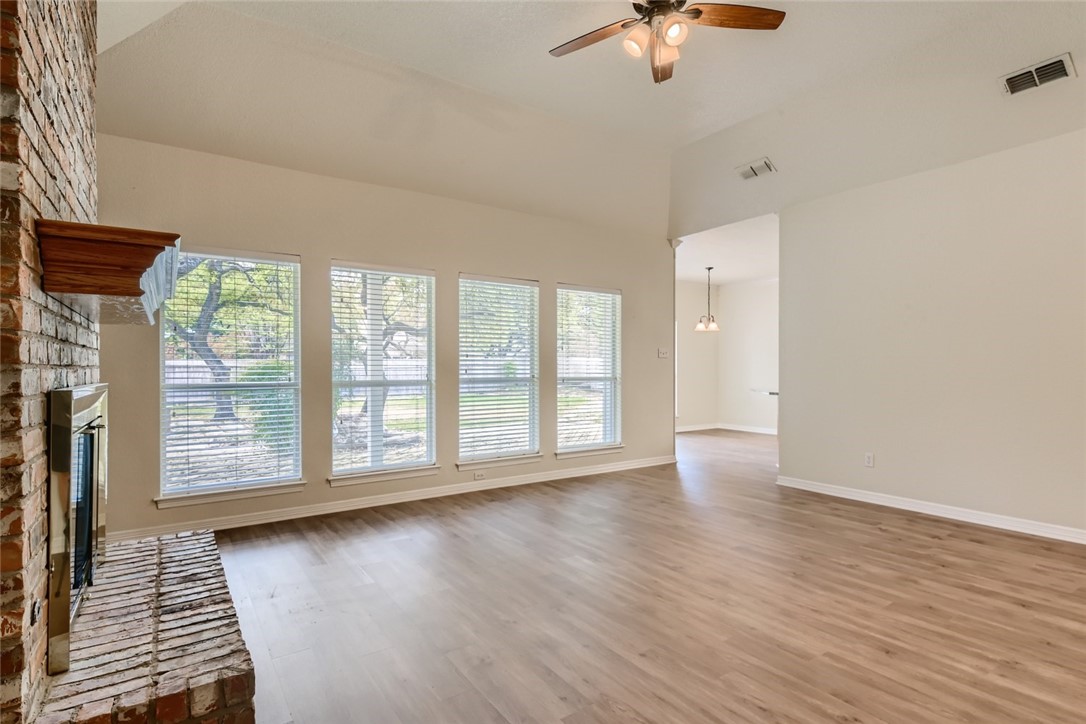 511 Susana Drive Georgetown, TX 78628 - Photo 9 of 31 Living room featuring vinyal plank flooring, ceiling fan, and large windows