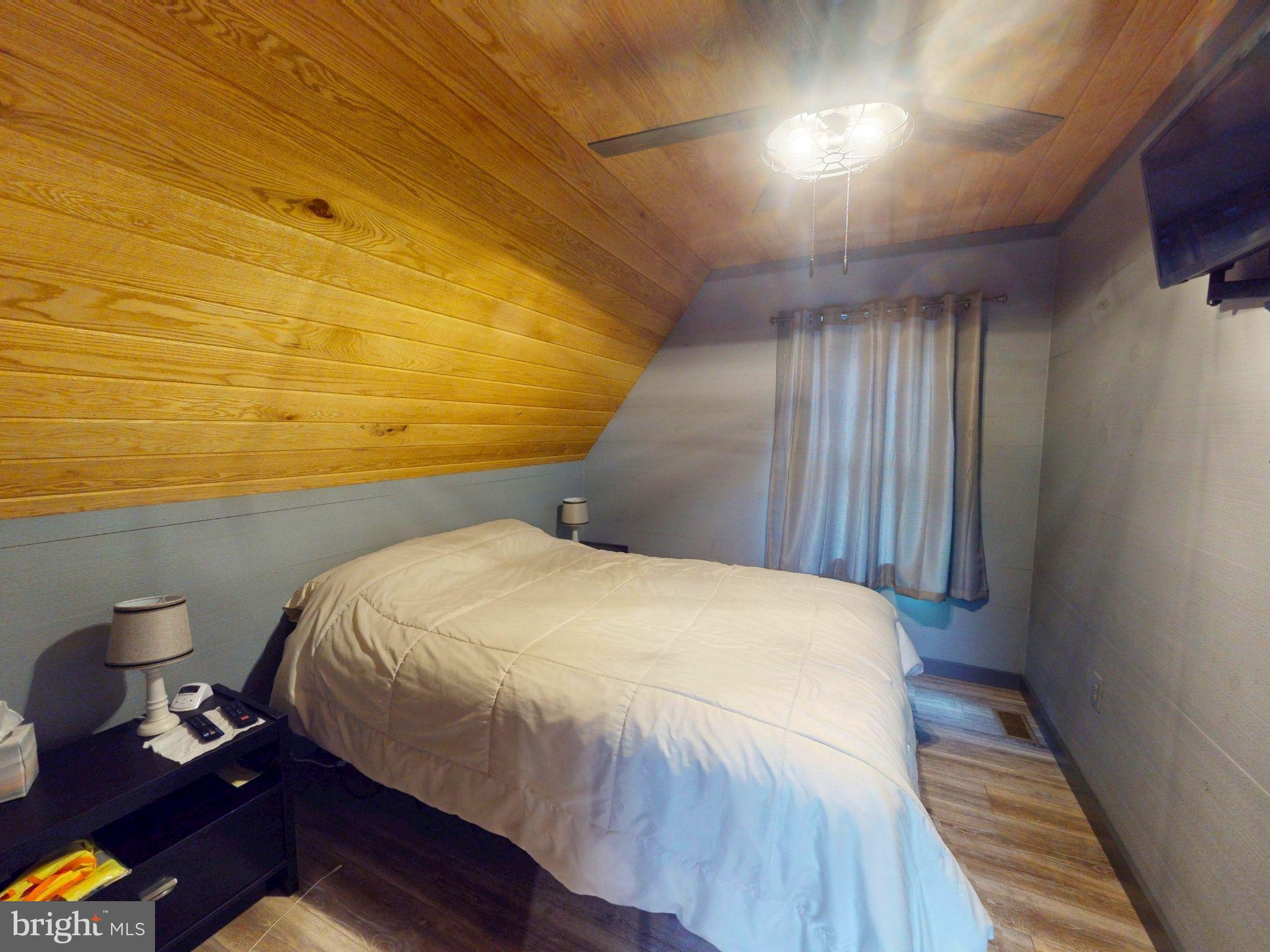 12076 Point Road Huntingdon, PA 16652 - Photo 12 of 13 a bedroom with a bed and wooden floor