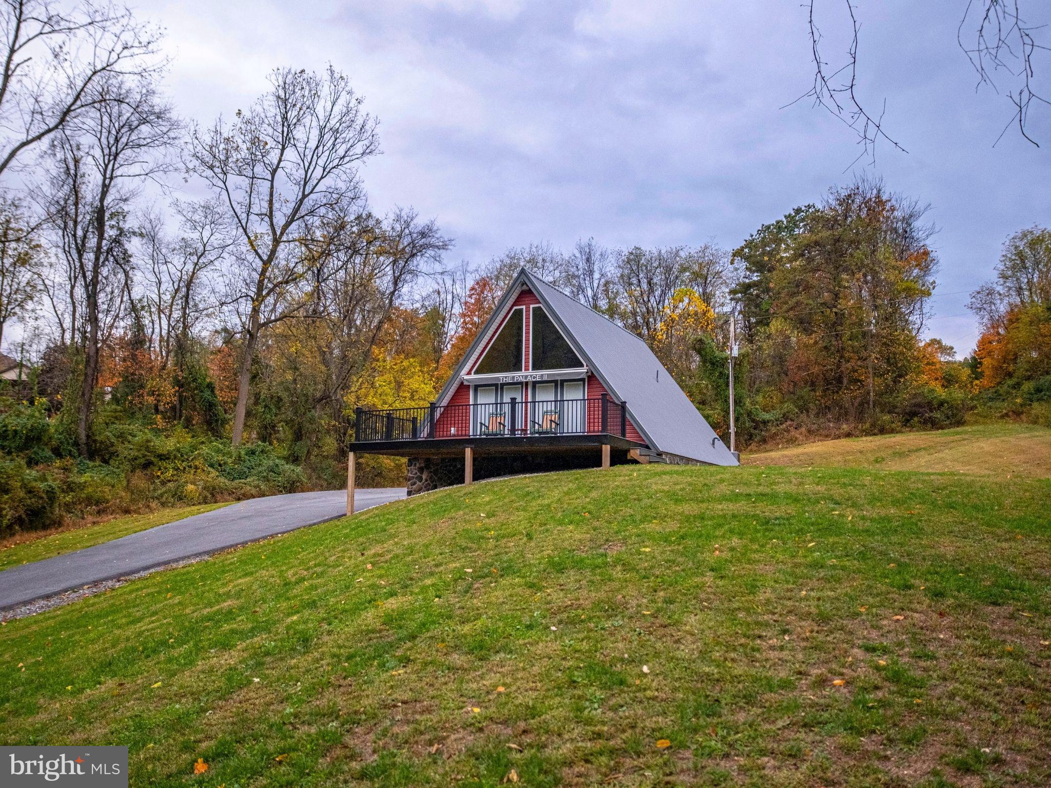 12076 Point Road Huntingdon, PA 16652 - Photo 2 of 13 a house with green field in front of it