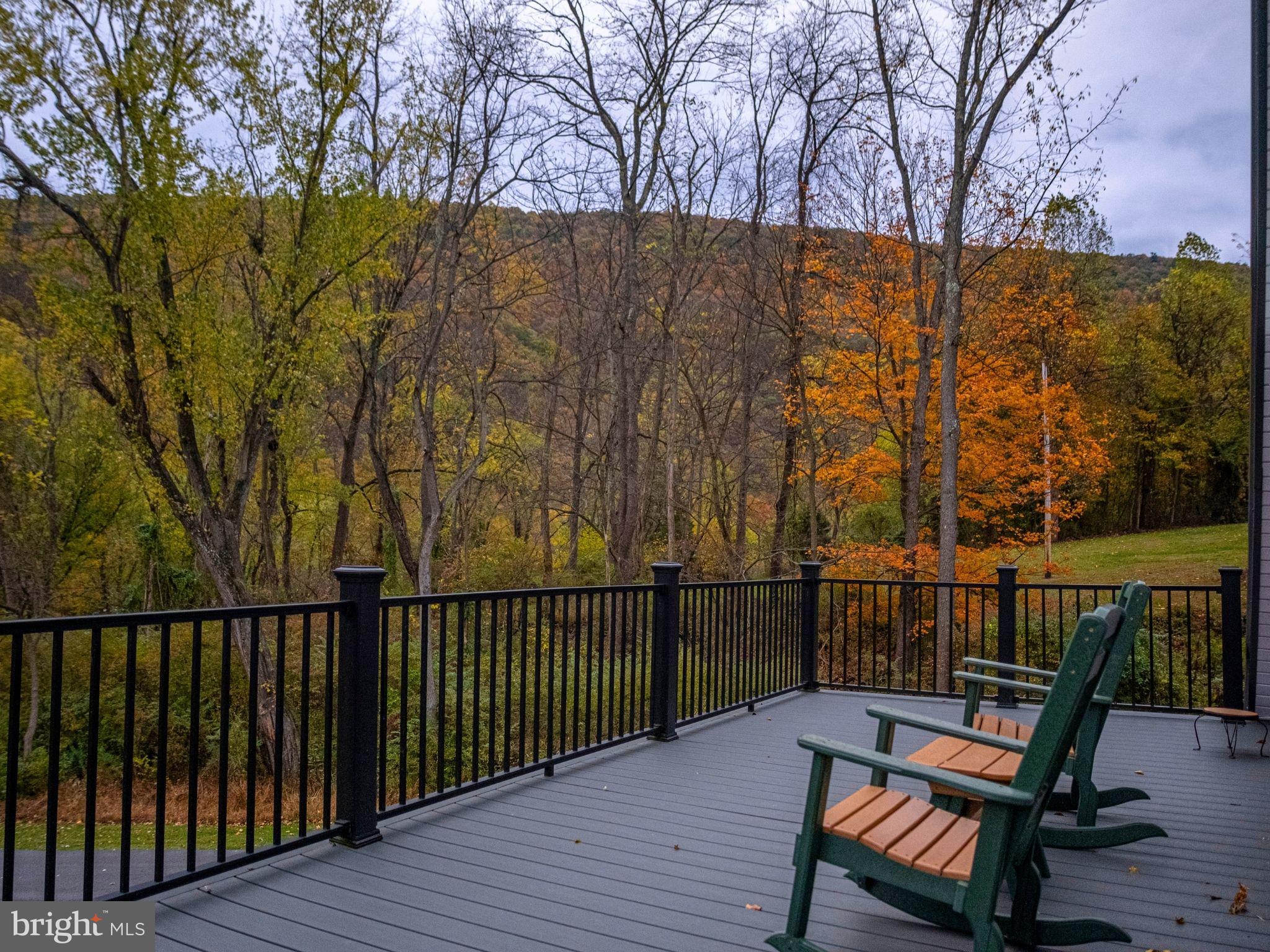 12076 Point Road Huntingdon, PA 16652 - Photo 4 of 13 a view of a roof deck with wooden fence and a couple of chairs