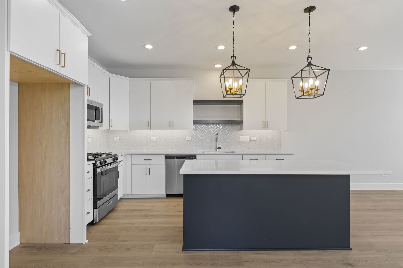 534 McCarthy Street Lemont, IL 60439 - Photo 9 of 23 a kitchen with a sink dishwasher a refrigerator a stove and white cabinets with wooden floor