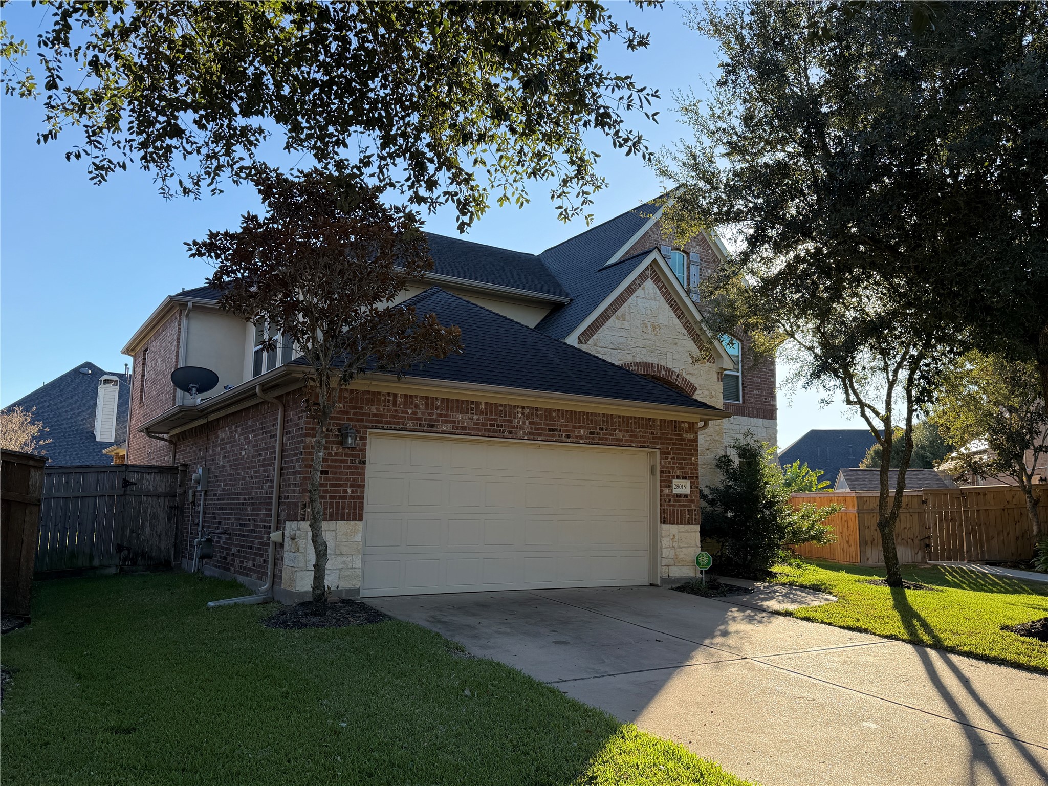 28015 Silverstream Court Fulshear, TX 77441 - Photo 2 of 33 a view of backyard of house with wooden fence