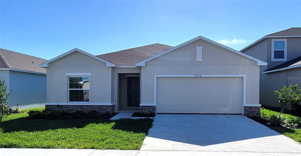 4798 Vellacito Way Davenport, FL 33897 - Photo 1 of 1 a front view of a house with garden