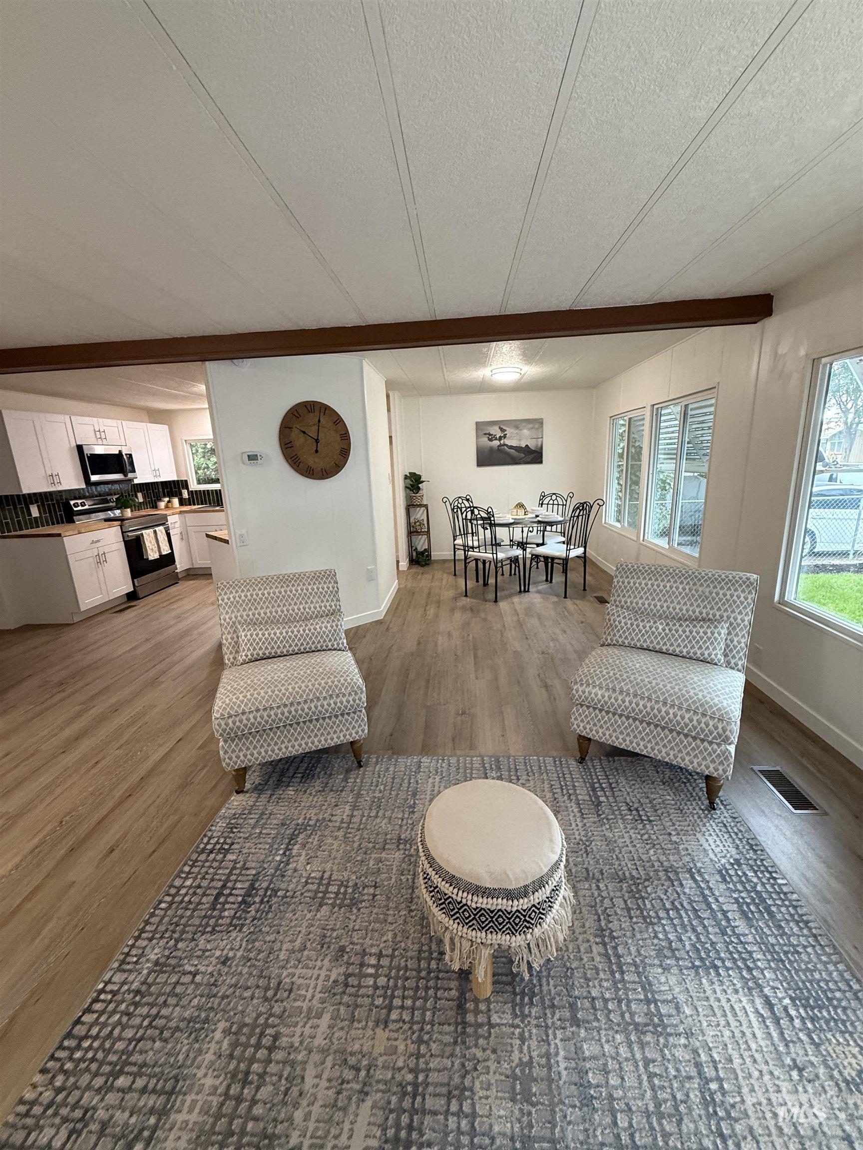 Living room featuring light wood-style floors and a textured ceiling