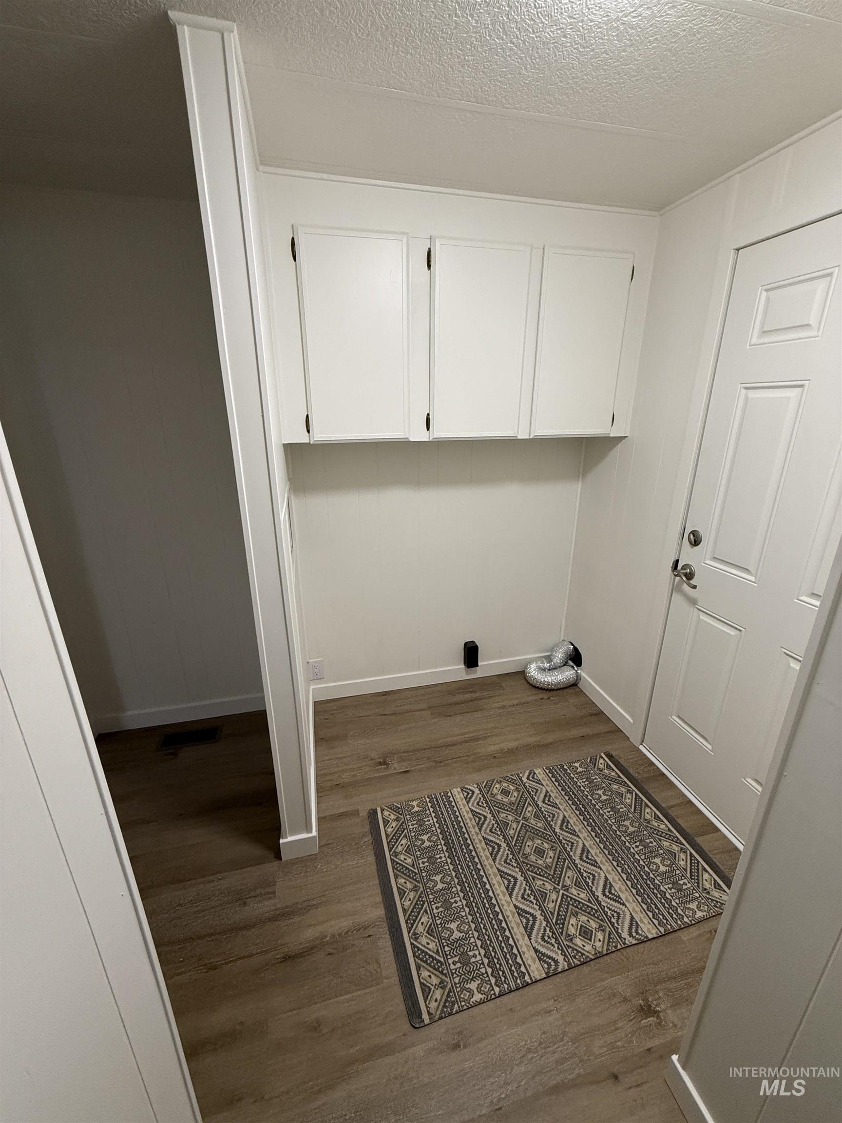 424 West Cherry Lane, Unit 5 Meridian, ID 83642 - Photo 13 of 27 Washroom featuring dark wood-style floors and a textured ceiling