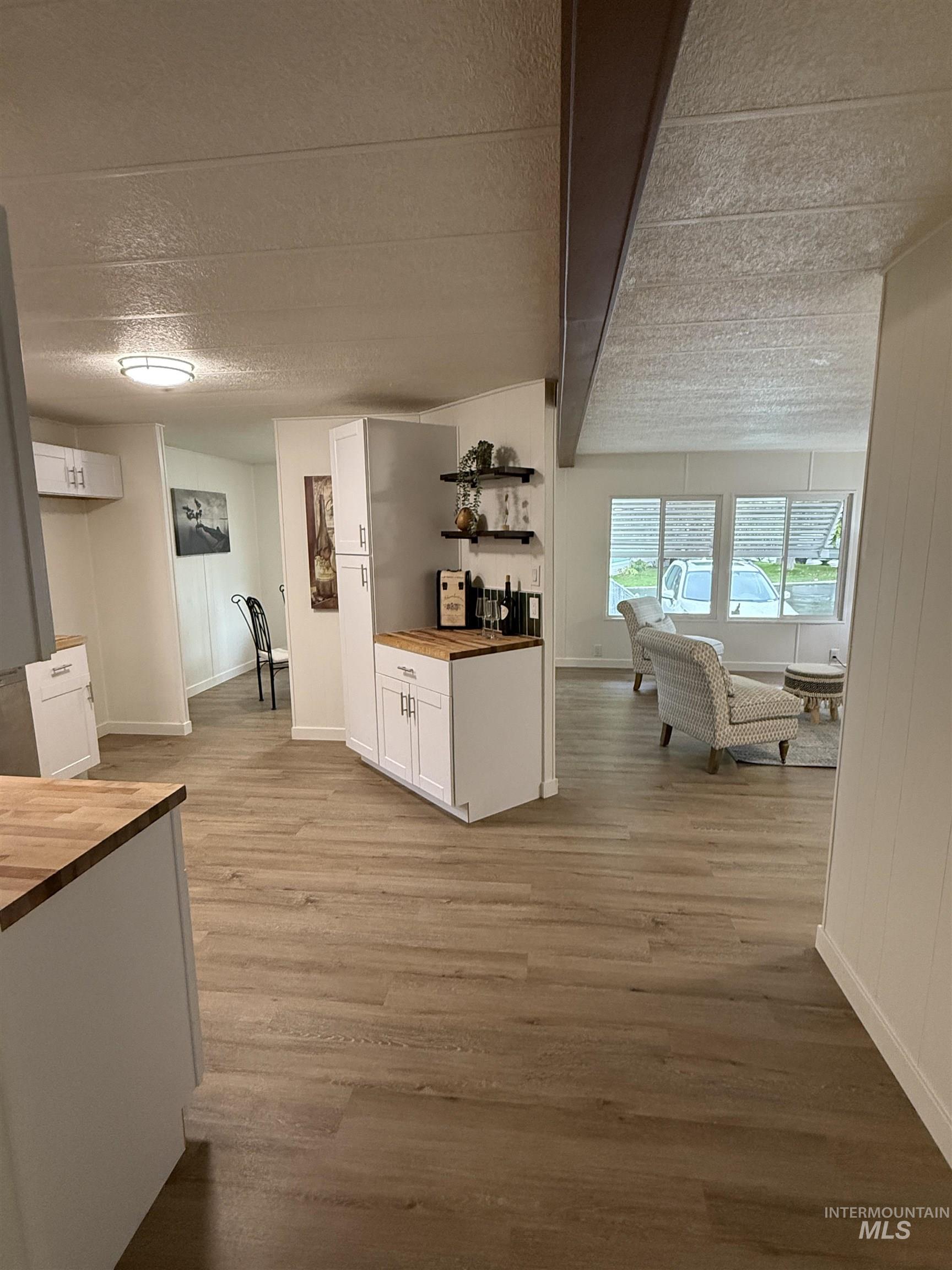 424 West Cherry Lane, Unit 5 Meridian, ID 83642 - Photo 10 of 27 Hall featuring a textured ceiling and light wood-type flooring