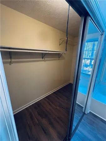 a view of closet with wooden floor