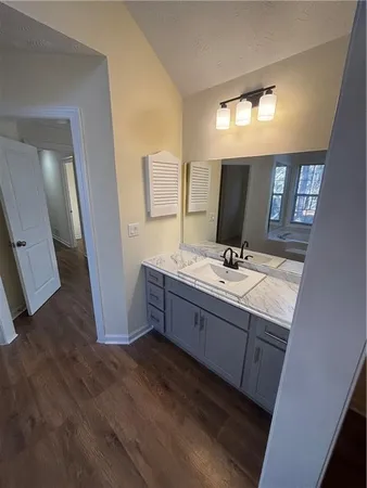 a bathroom with double vanity sink and a mirror