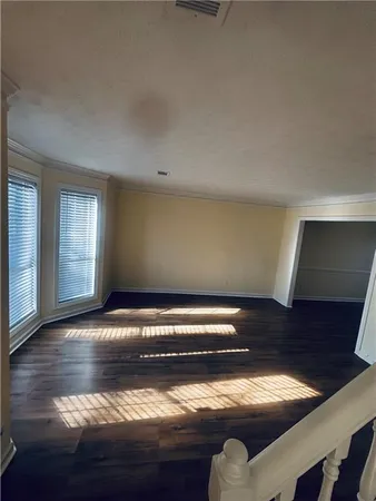 a view of water heater room with wooden floor