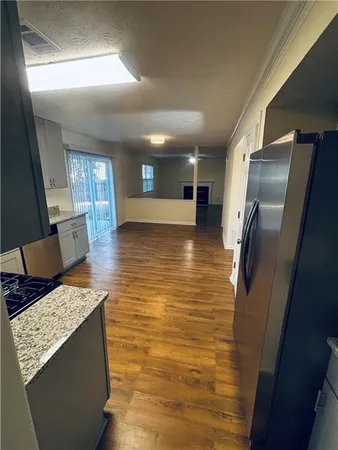 a view of kitchen with furniture and wooden floor