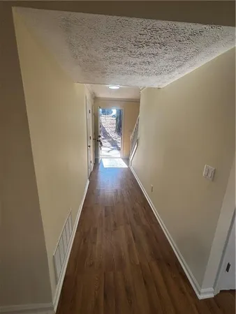 a view of hallway with wooden floor