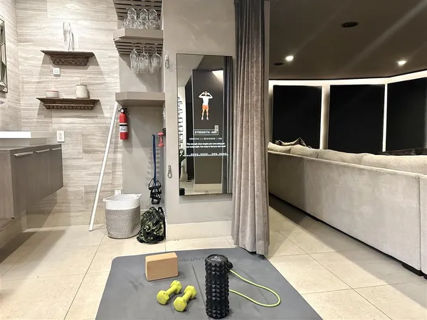 a hallway with a view of living room with wooden floor