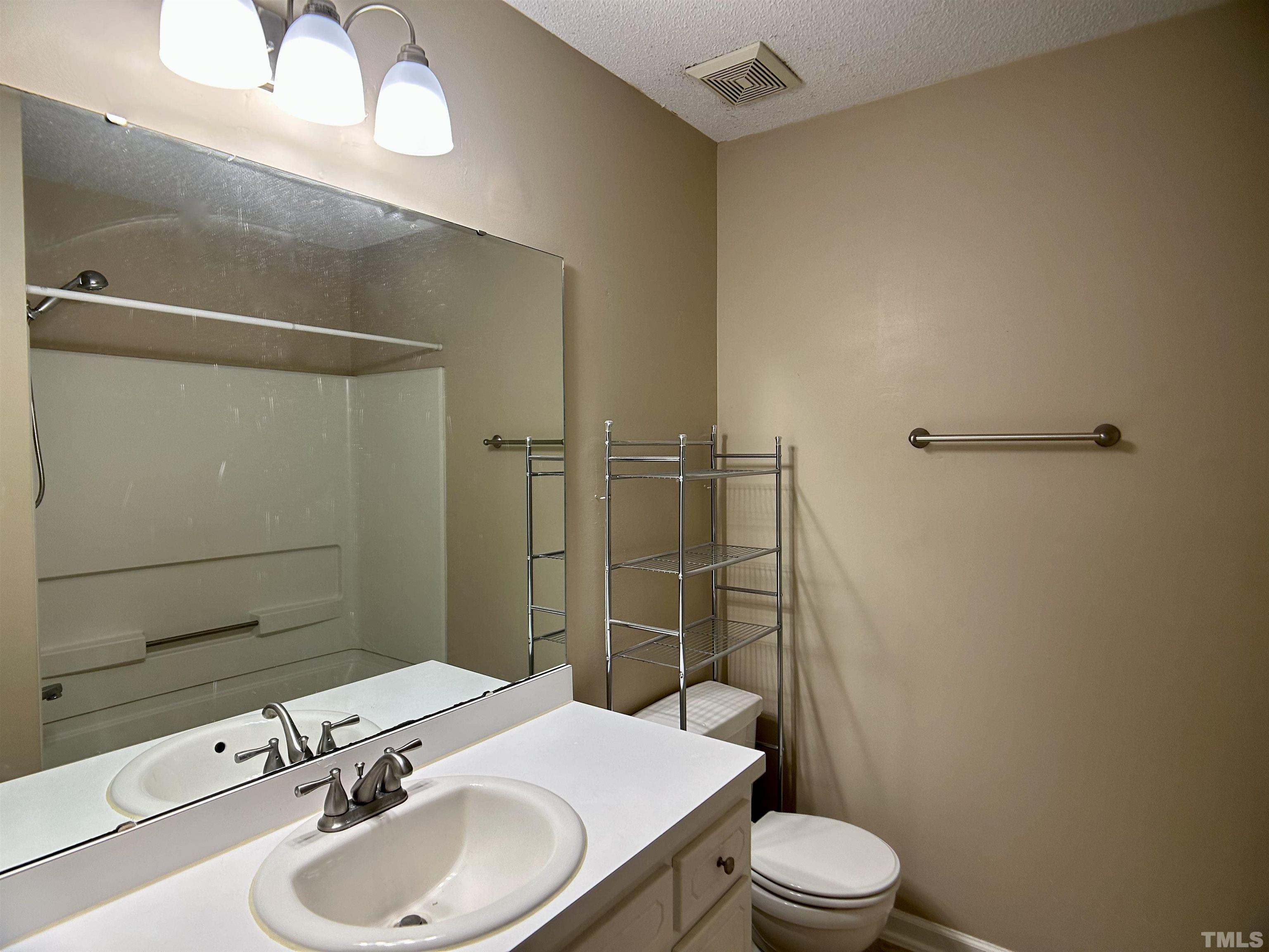 316 Amber Lane Willow Spring, NC 27592 - Photo 12 of 18 a bathroom with a sink toilet and shower
