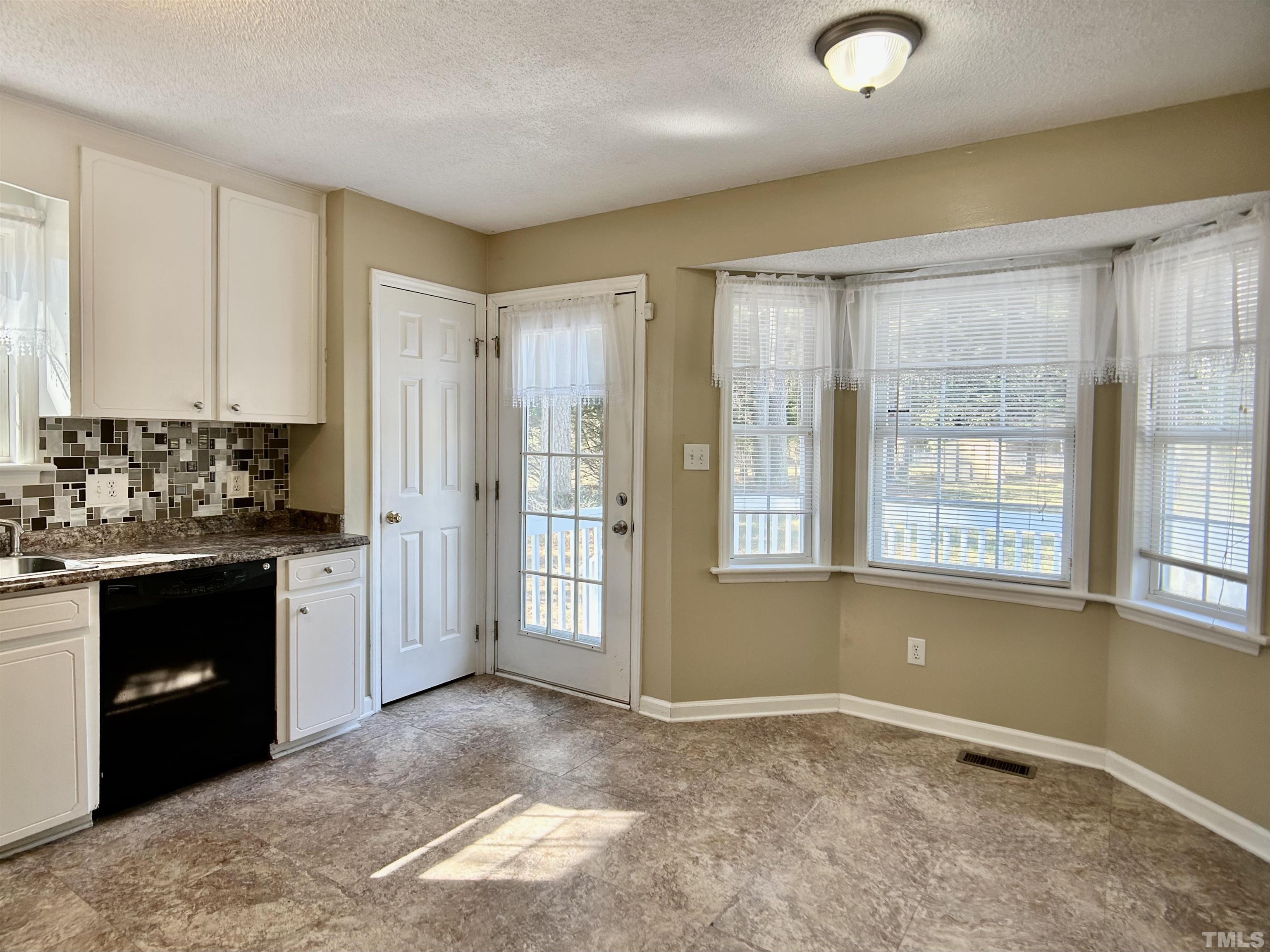 316 Amber Lane Willow Spring, NC 27592 - Photo 4 of 18 a view of an empty room with a kitchen