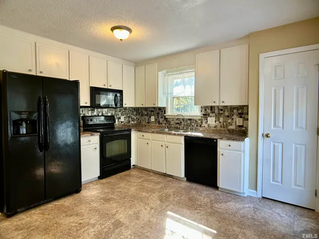 a kitchen with a refrigerator stove and microwave
