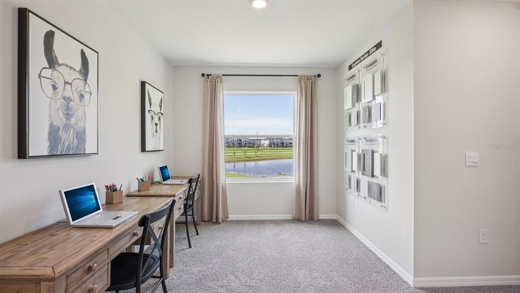 32479 Welling Blade Loop Wesley Chapel, FL 33545 - Photo 15 of 39 a view of a workspace with furniture and a window