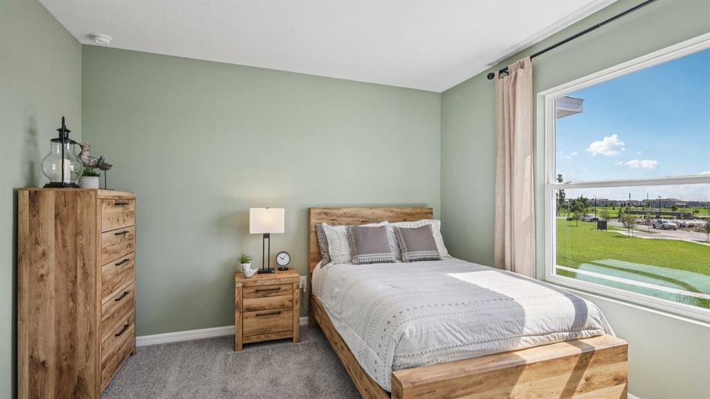 32479 Welling Blade Loop Wesley Chapel, FL 33545 - Photo 26 of 39 a bedroom with a bed and a window