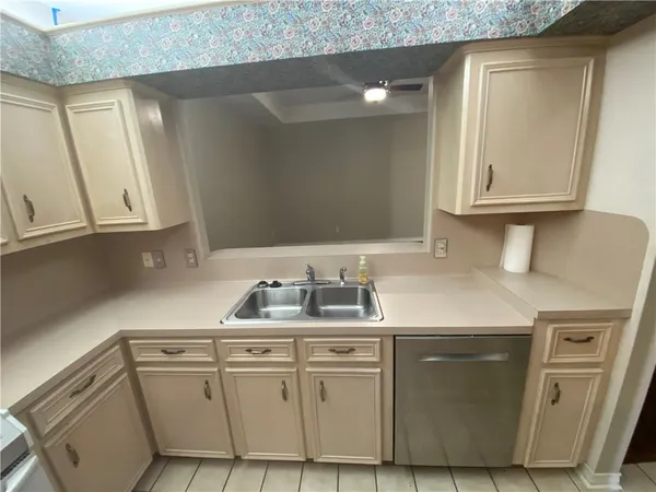a kitchen with cabinets appliances and a sink