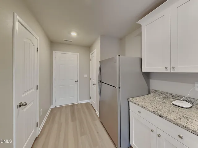 a kitchen with a refrigerator and cabinets