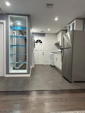 a view of a refrigerator in kitchen and wooden floor