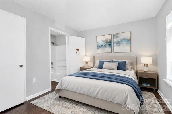 a bedroom with a bed and a painting on the wall