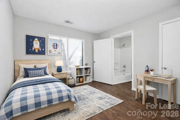 a bedroom with a bed and a table in it
