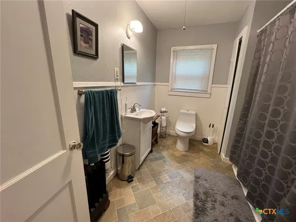 a bathroom with a toilet and a shower