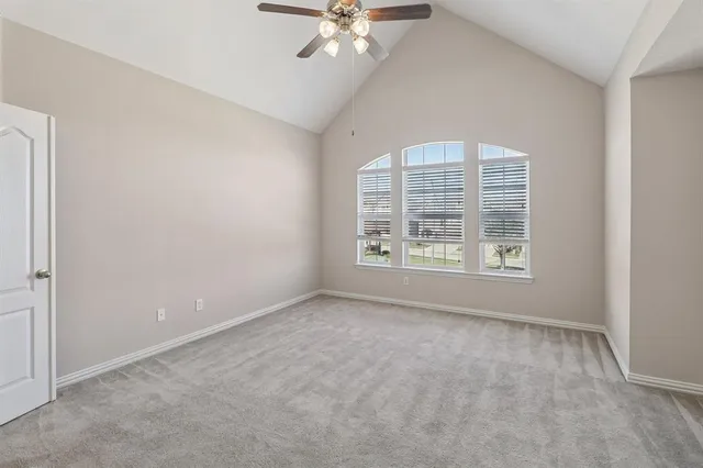 an empty room with fan and entrance