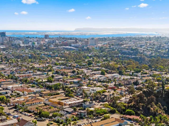 an aerial view of residential houses with city view