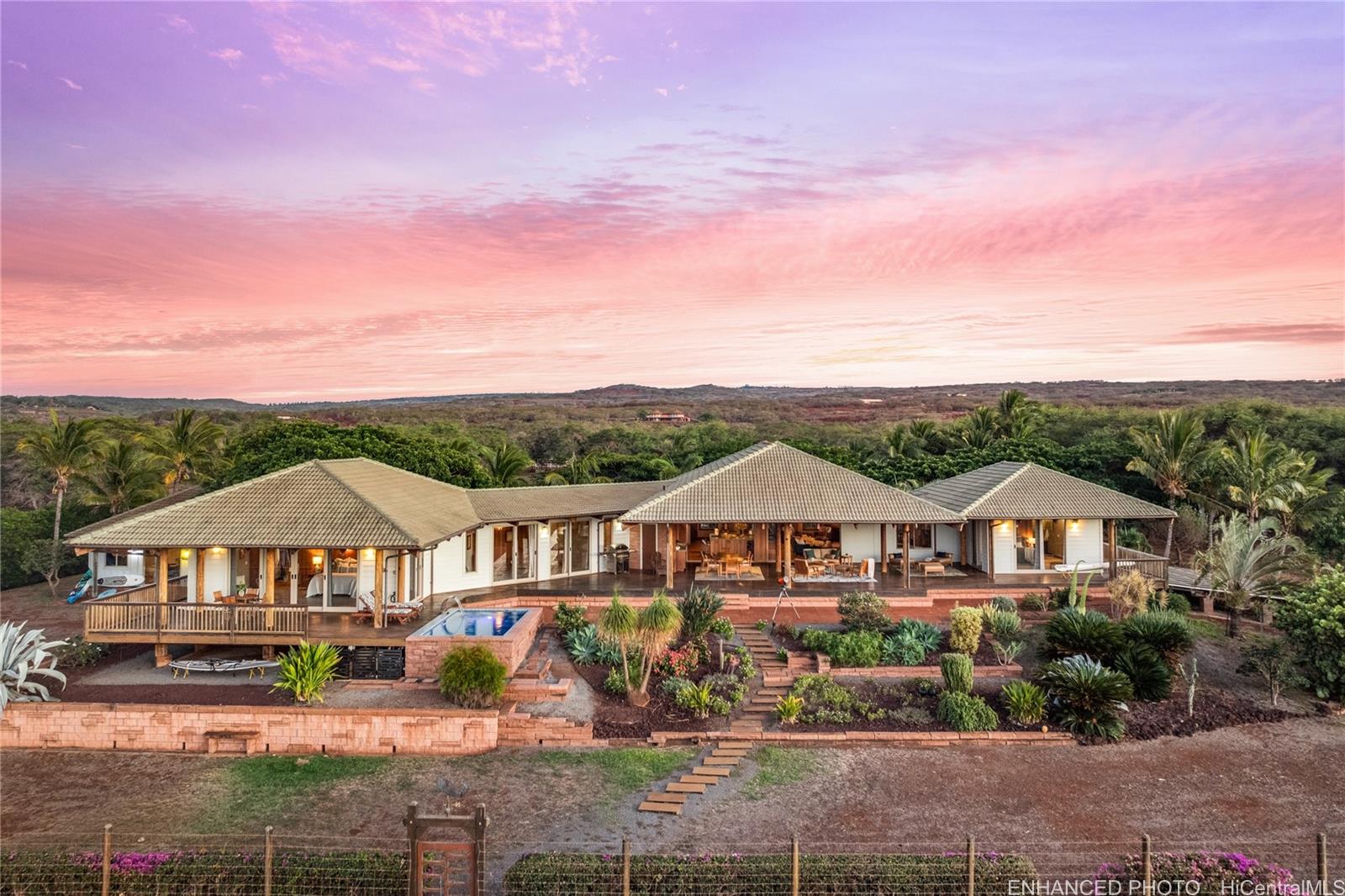 an aerial view of a house with yard patio and outdoor seating