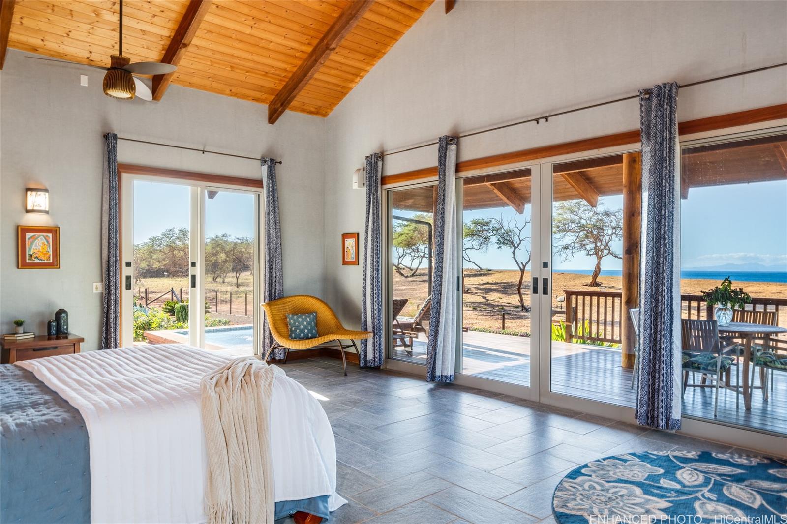 3036 Kalua Koi Road Maunaloa, HI 96770 - Photo 13 of 25 a bedroom with a bed and large window